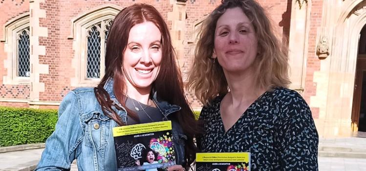two women outside Lanyon holding brochures